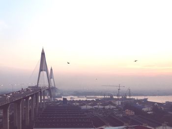 Kanchanaphisek bridge over chao phraya river against sky during sunset