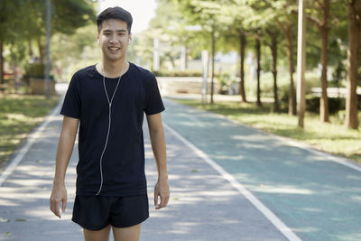 Portrait of smiling young man standing in city