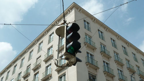 Low angle view of road signal against building