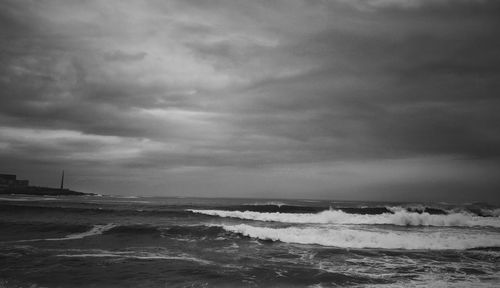 Scenic view of sea against cloudy sky