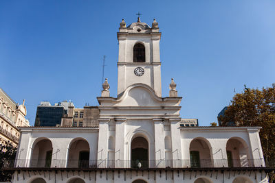 Low angle view of building against clear blue sky