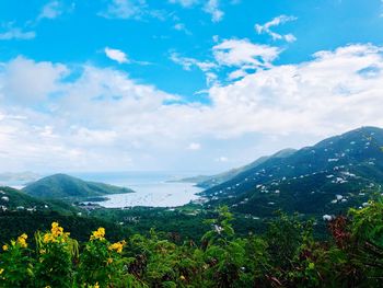 Scenic view of sea and mountains against sky