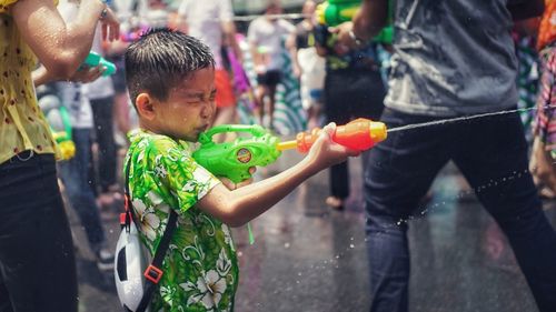 Rear view of people standing on street