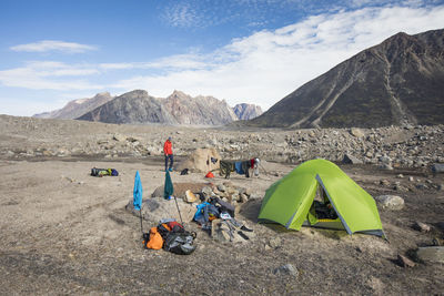 Drying out wet clothes at a remote campsite in akshayak pass.