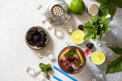 High angle view of fruits and drink on table