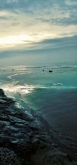 Scenic view of sea against sky at sunset