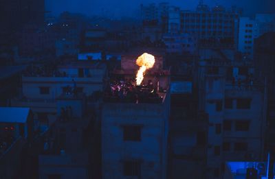 High angle view of people around bonfire during shakrain festival