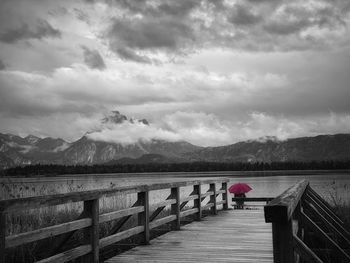 Rear view of man on lake against sky