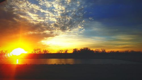 Scenic view of silhouette trees against sky during sunset