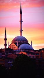 Building against sky during sunset in city