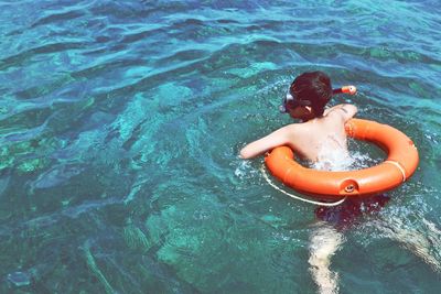 High angle view of boy swimming in sea