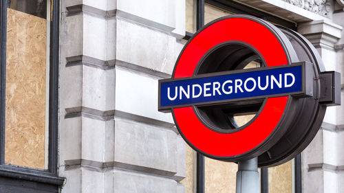 Close-up of road sign against built structure