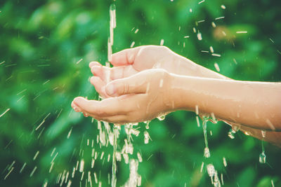 Cropped hand of woman holding sparkler