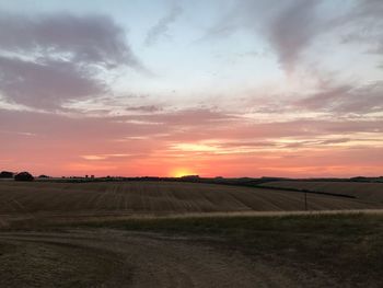 Scenic view of field against sky during sunset