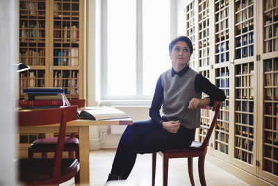 Female lawyer looking up while sitting in library