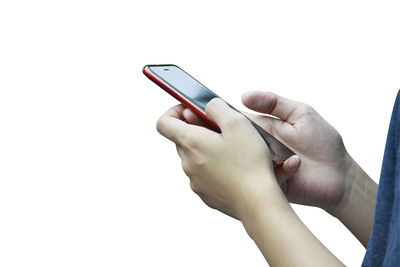 Cropped hands of woman using mobile phone against white background