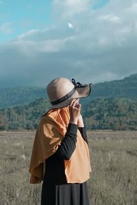 Full length of man wearing hat standing on field