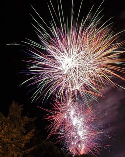 Low angle view of firework display at night