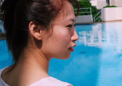 Close-up of young woman looking away