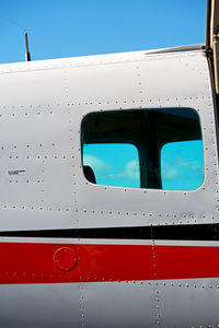 Close-up of airplane window against clear sky