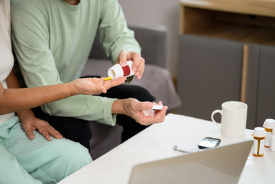 Midsection of doctor explaining to client in office