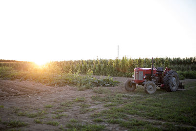 Tractor on field against clear sky