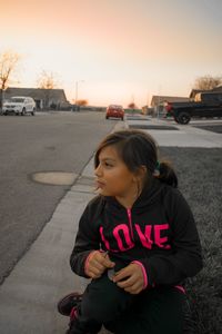 Full length of boy on road in city against sky