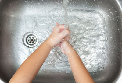 Midsection of child in bathroom at home