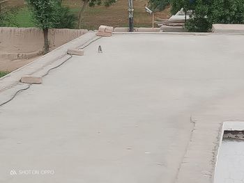 High angle view of empty footpath by building