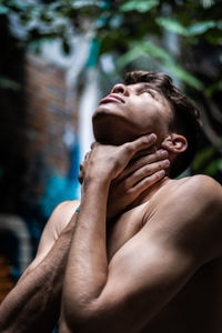 Shirtless man standing outdoors