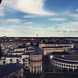 Buildings against cloudy sky