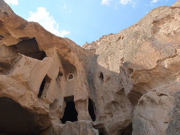 Low angle view of rock formations against sky