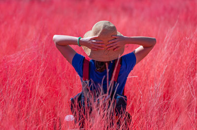 Portrait of woman walking in red meadow in summer