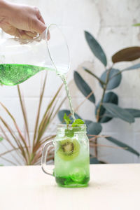 Close-up of hand holding glass of table