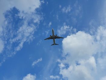 Low angle view of airplane flying in sky