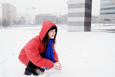 Young woman wearing hat on field during winter