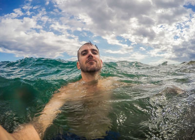 Portrait of man in sea against sky