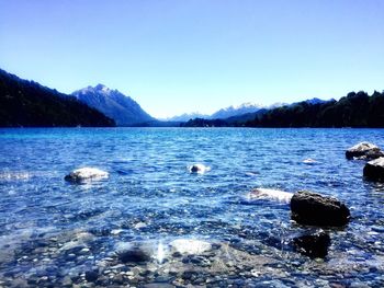 Scenic view of frozen lake against blue sky