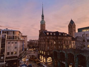 Buildings in city at sunset