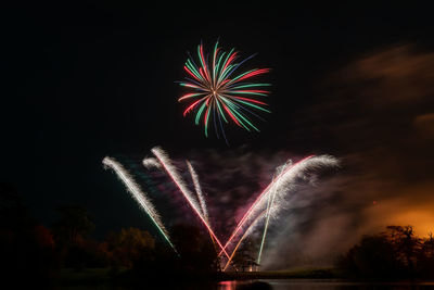 Low angle view of firework display at night