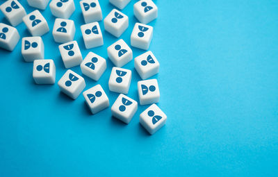 High angle view of dices on blue background