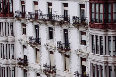 Window on the white facade of the building on the street