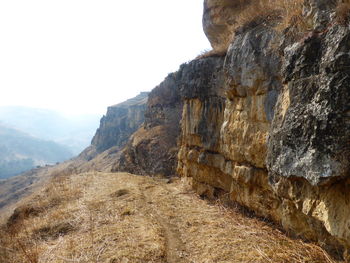 Rock formations on landscape against sky