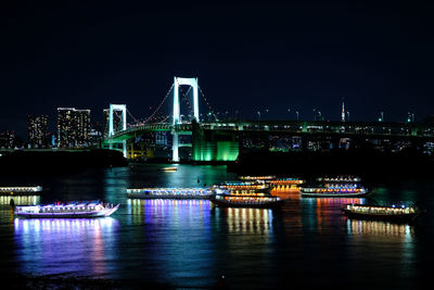 Illuminated city at waterfront