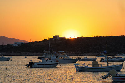 Boats in marina at sunset