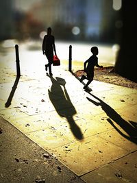 Silhouette children playing on floor