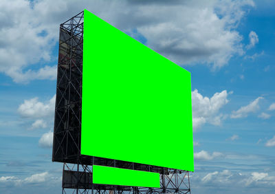 Low angle view of sign against sky