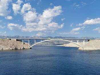 View of bridge over sea against cloudy sky