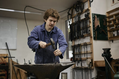 Blacksmith working in his workshop