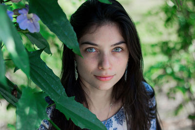 Portrait of beautiful young woman standing at park